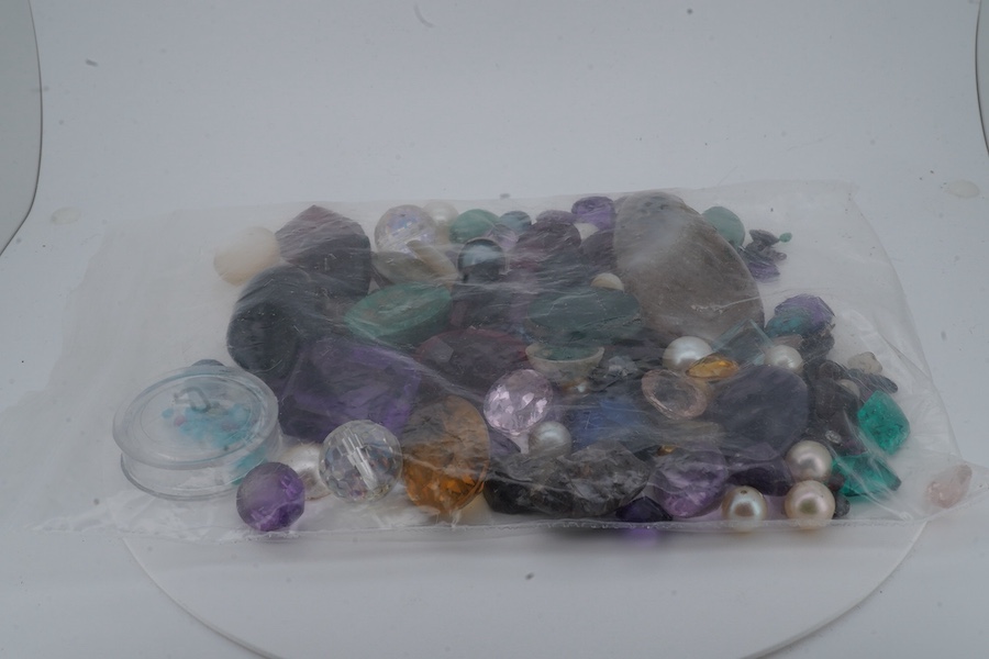 A bag of loose stones, including amethysts, garnets, cultured pearls, a quantity of small diamonds and rubies, jadeite beads, a green chrysoprase intaglio depicting the cathedral of St Stephen, Vienna, and various synthe